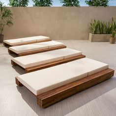 three wooden benches sitting next to each other on a patio