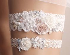 three garters with flowers and pearls on them