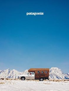 a truck is parked in the snow with mountains in the background and a sign that reads patagonia