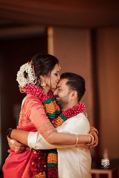 a bride and groom embracing each other