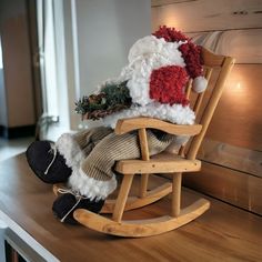 a teddy bear sitting on top of a wooden rocking chair