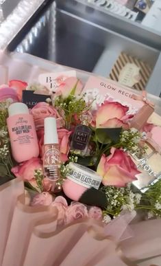 a bouquet of flowers and beauty products in a box