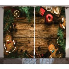 a wooden table with christmas decorations on it and two curtains hanging from the wall behind them