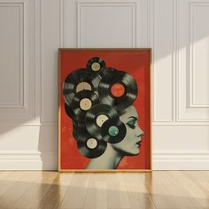 an art piece with records in the shape of a woman's head on a wood floor