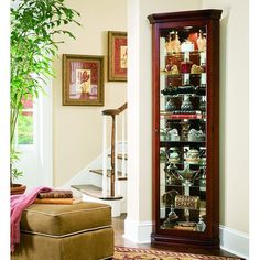 Pulaski Furniture Victorian Cherry Corner Curio, 21001-p. In just 16  of wall space, our curio allows you to maximize space and bring art and light into a room. That s smart design. The traditional curio features classic moldings, canted corners, and incised glass. It is built in select hardwood solids and veneers features with a rich Victorian Cherry finish. Our curio includes a lighted interior, mirror back, and adjustable glass shelves with plate grooves.Pulaski Furniture Curios Collection SKU: 21001-p Bedroom Furniture Redo, Corner Curio Cabinet, Corner Curio, Furnitur Ruang Keluarga, Living Room Corner, Glass Cabinets Display, Pulaski Furniture, Furniture Redo, Corner Cabinet