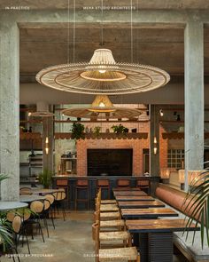 the interior of a restaurant with tables, chairs and an open fire place in the center