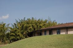 a building on top of a hill with trees in the background