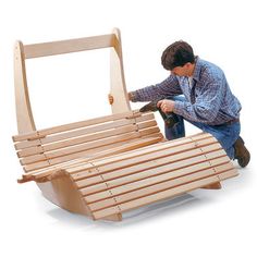 a man is working on a wooden bench