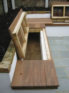 a wooden bench sitting on top of a stone patio