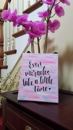 there is a sign that says even struggle take a little time on the table next to some flowers