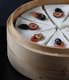 a wooden container filled with food on top of a table