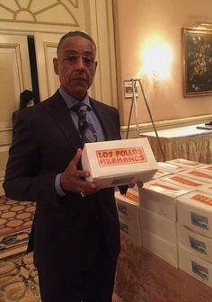 a man in a suit and tie holding a box