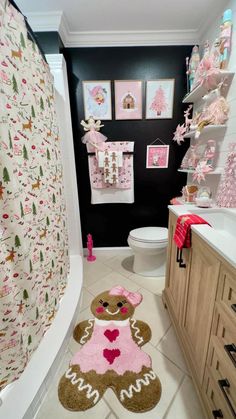 a bathroom decorated in pink and brown with teddy bears on the rugs, toilet paper towels and wall hangings