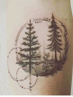 a tattoo on the leg of a person with trees and circles around it, in front of a white background