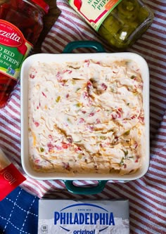 a casserole dish is sitting on a red and white towel