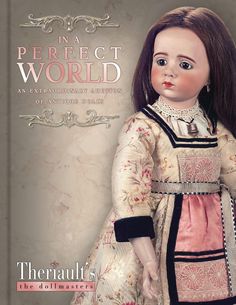 the doll is wearing a pink dress with black trimmings and has long brown hair