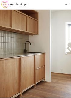 an empty kitchen with wooden cabinets and white walls, is pictured in this image from the webpage