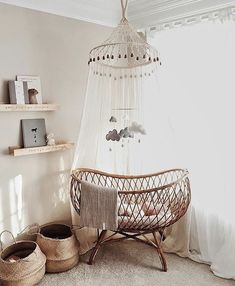 a baby's crib in the corner of a room with shelves and baskets