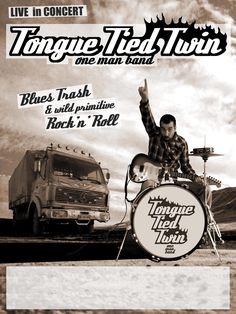 a man sitting on top of a drum kit next to a truck in the desert