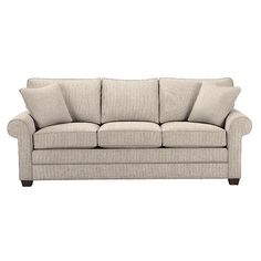 a beige couch with pillows on it