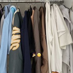 a closet with clothes hanging on hooks