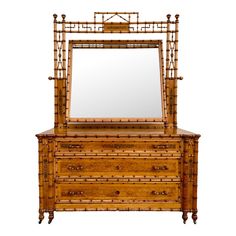 an antique bamboo dresser with mirror on top