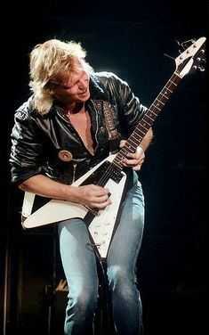 a man playing an electric guitar on stage