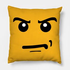 a yellow pillow with an angry face drawn on it