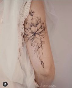 a woman's arm with a flower tattoo on the left side of her body