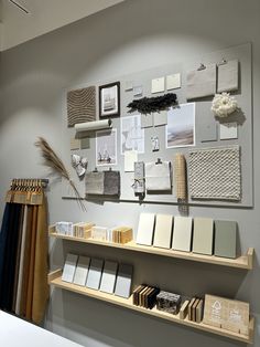 the interior of a store with many items on shelves and pictures hanging on the wall