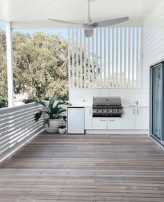 an outdoor kitchen and grill on a deck