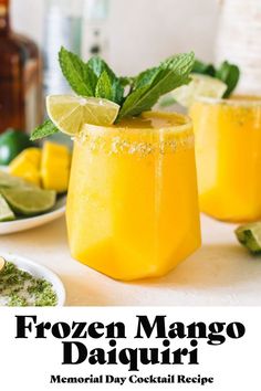 the frozen mango daiquita cocktail is ready to be served with lime and mint