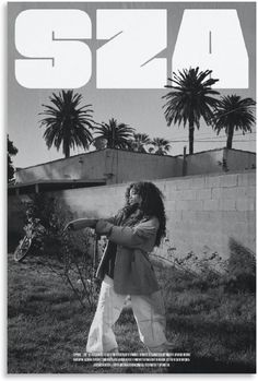 a black and white photo of a person holding a bike in front of palm trees