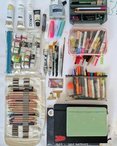 the contents of an art supply bag are neatly organized