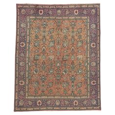 an antique persian rug with floral design on the center and purple, blue, green, red