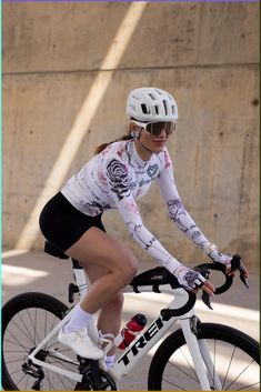 a woman riding a bike down a street