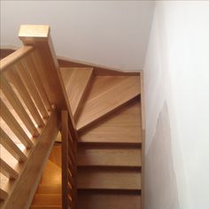 the stairs are made of wood and have handrails