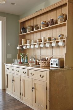 a kitchen with wooden cabinets and shelves filled with dishes