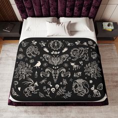 a bed with black and white designs on it