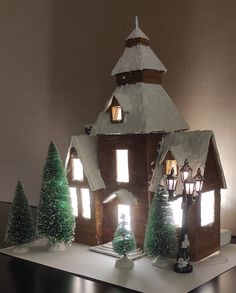 a house made out of paper with lights on it