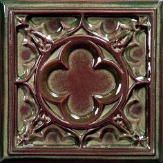 a decorative tile with an ornate design on it