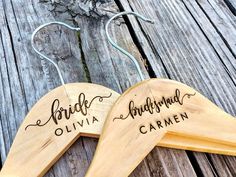 two wooden hangers with names on them