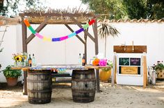 an outdoor bar with wine barrels and decorations