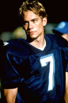 a man in a football uniform standing on the field