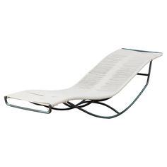 a white chaise lounge chair with black metal legs and arms, viewed from the side