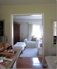 a living room filled with furniture next to a doorway