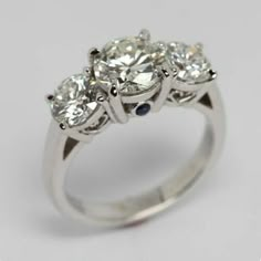 three stone diamond ring on white background