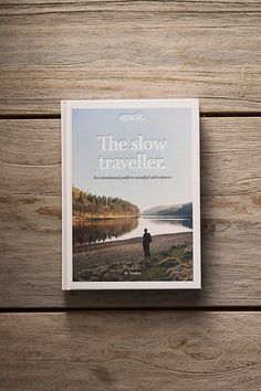 the slow traveler book on a wooden surface