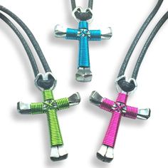 three different colored cross pendants on black leather cord with silver metal fittings and clasps