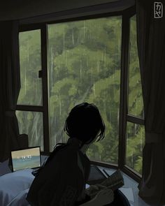 a person sitting in front of a window looking out at the rain outside and holding an open book